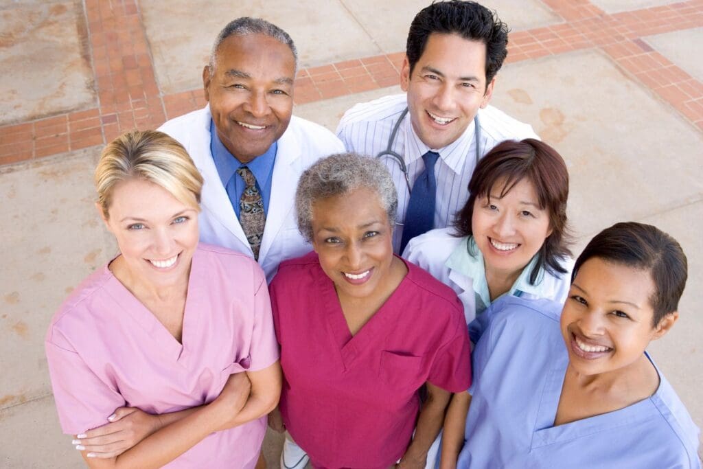 A group of doctors and nurses standing together.