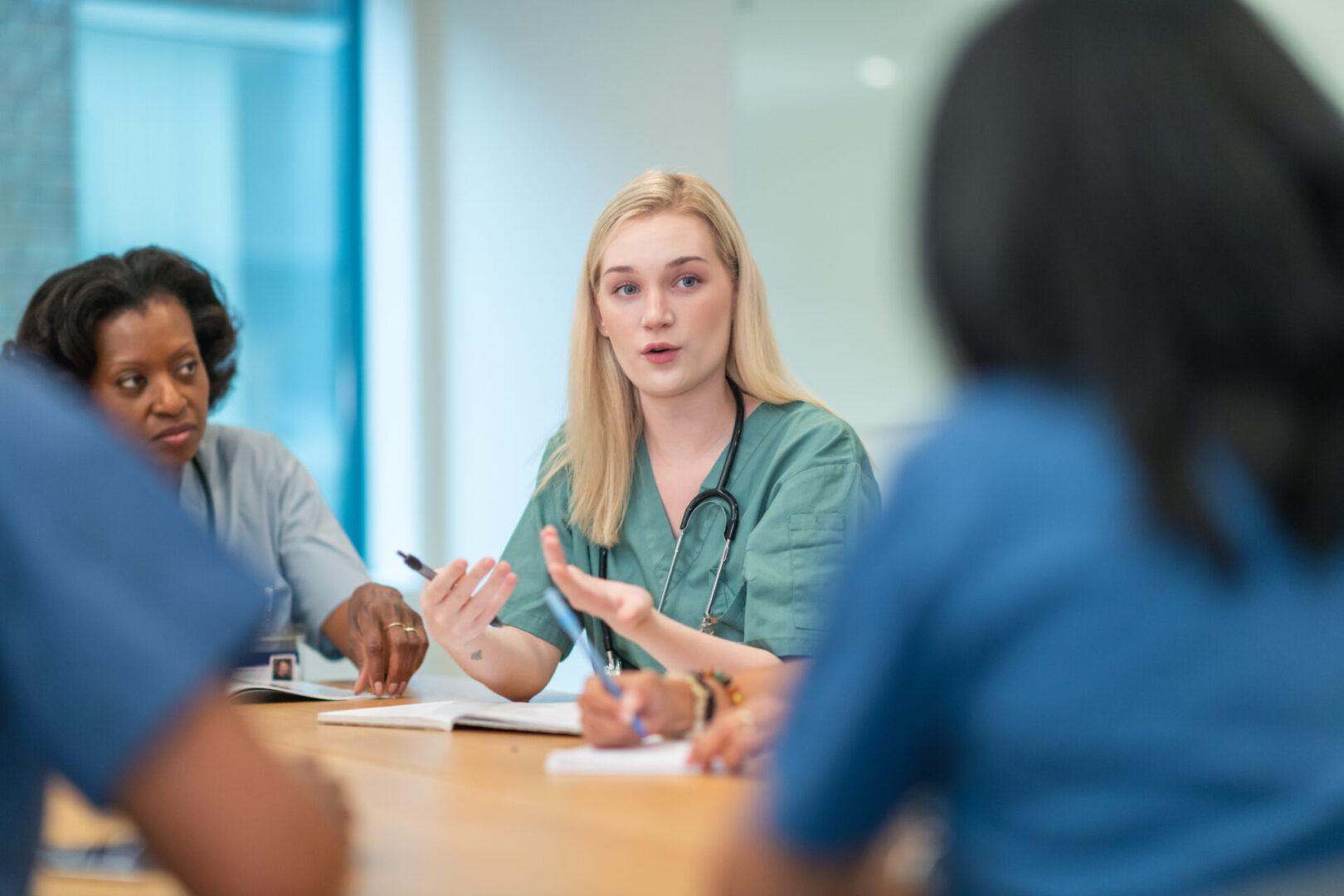 A woman sitting at a table with other people.