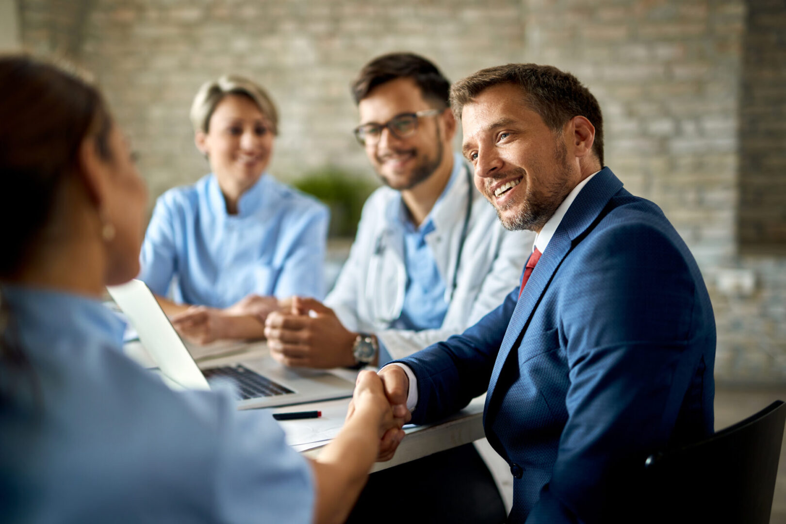 A group of people sitting around a table.