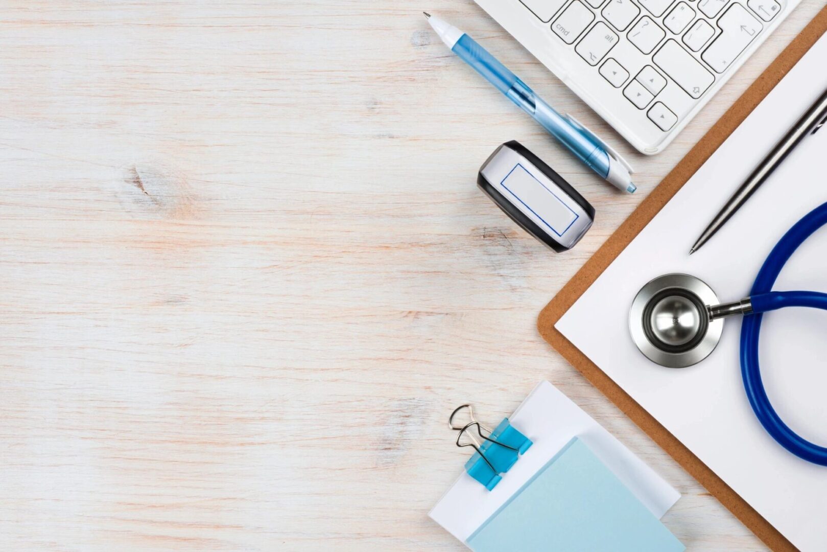 a pen, stethoscope, sticky notes, and a keyword